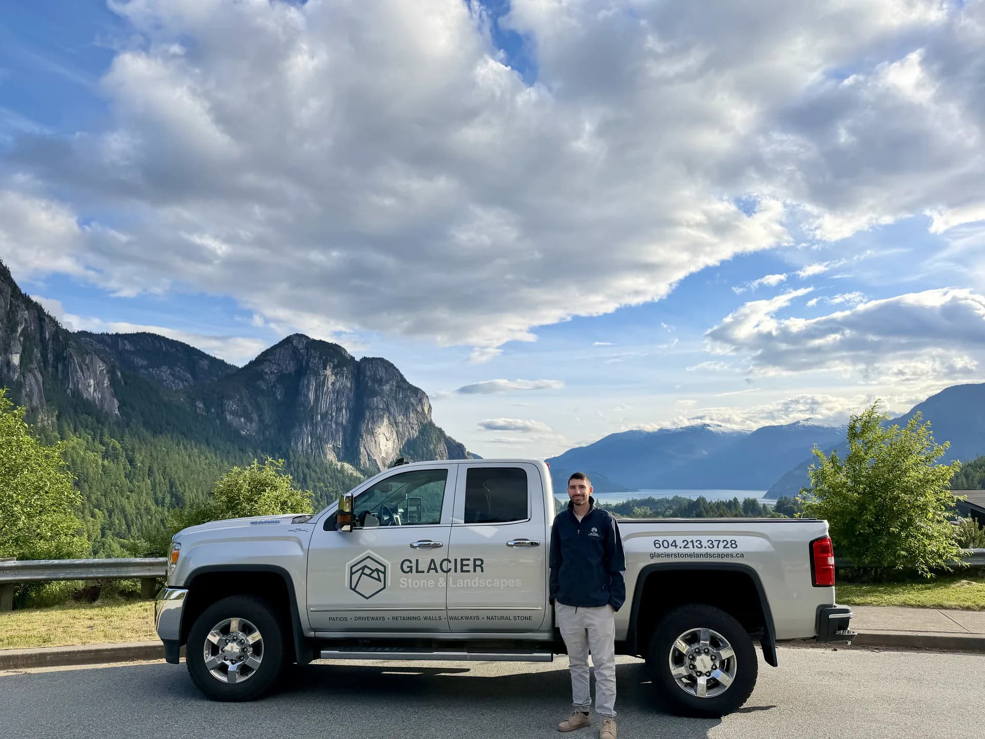 A Glacier truck parked above Howe Sound, the Stawamus Chief behind